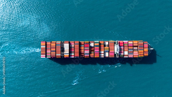 Obraz Top view Cargo Container ship with contrail in the ocean ship carrying container and running for import export concept technology freight shipping by ship.