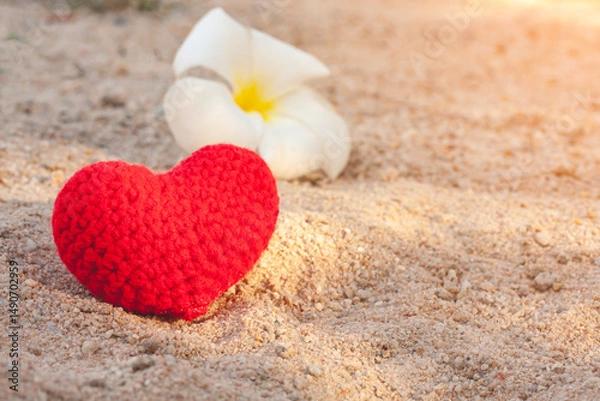 Fototapeta sweet heart on sand beach under sunset and warm light.