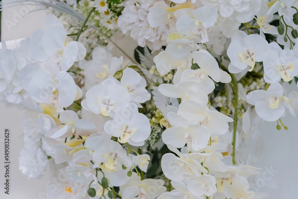 Obraz Fluffy white hydrangeas and delicate white filler flowers complete the lush and harmonious display. 
The bright lighting enhances the pure white tones, creating a soft and serene aesthetic.