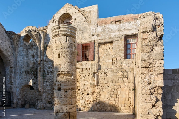 Fototapeta The ancient architecture of the Church of the Virgin Mary of the Burgo in Rhodes, Greece, showcasing medieval stone walls and structures.