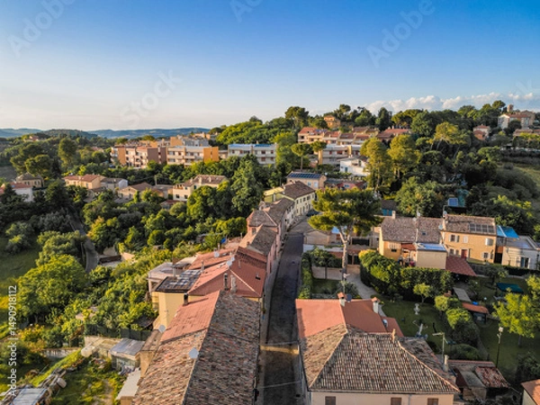 Fototapeta Italy, May 15, 2025: aerial view of the medieval village of Candelara in the province of Pesaro in the Marche region. The town exudes ancient history and serenity
