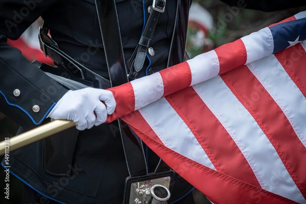 Fototapeta Color guard rolling up the US flag
