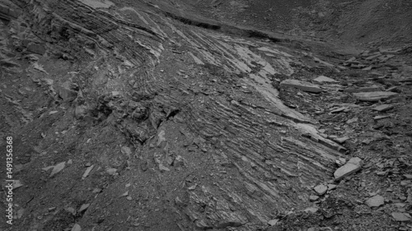Fototapeta Layers and cracks in sedimentary rock on cliff face.