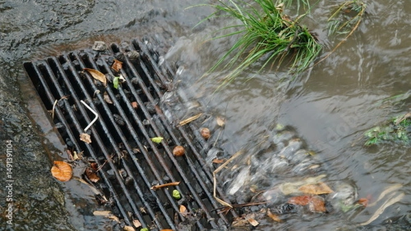 Obraz Rainwater flows over the ground and into the culverts or gutters