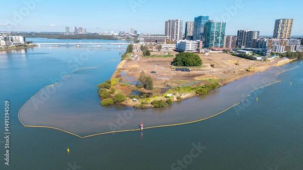Obraz The Sydney suburb of Wentworth point  with barriers on the Parramatta river to prevent pollution during construction.
