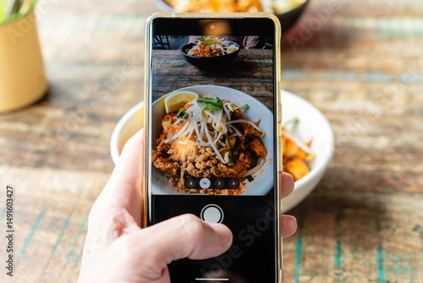 Fototapeta POV shot of taking photo of a meal using the camera app of a smartphone