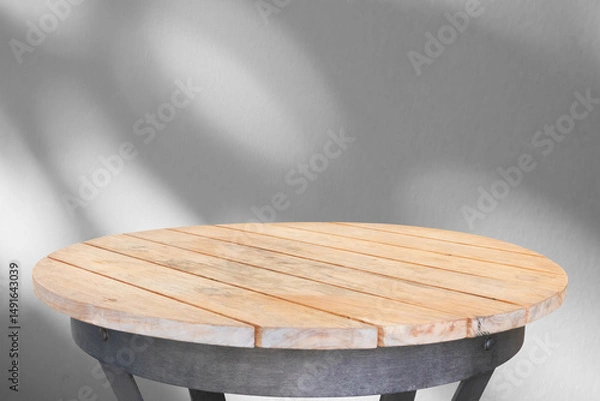 Fototapeta Round wood table top with tree leaves shadow drop on white wall background for mockup product display