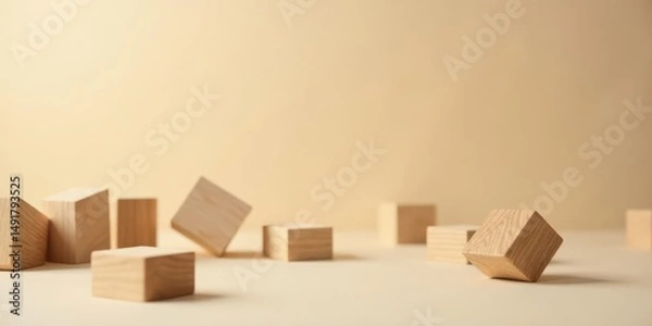 Fototapeta A collection of light-colored wooden blocks scattered on a neutral background, showcasing simple geometric shapes and minimalist design aesthetics