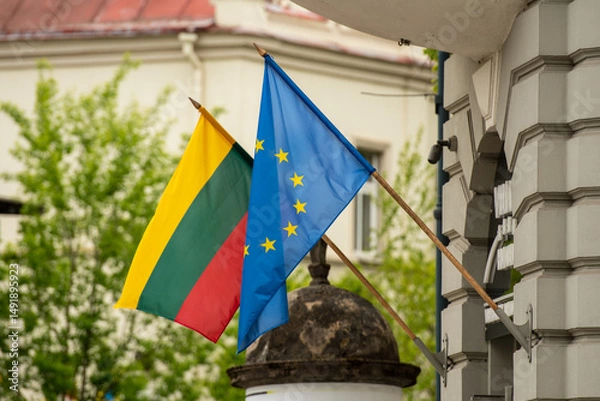 Fototapeta Flag of European Union and Lithuanian flag waving together in the streets of Vilnius, Lithuania