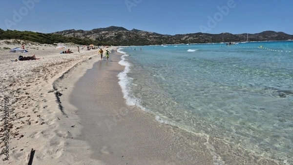 Obraz white sand, a few rocks and crystal clear water at the beach of plage de saleccia in corsica