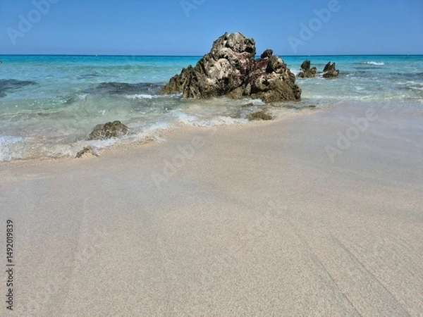 Obraz white sand, a few rocks and crystal clear water at the beach of plage de saleccia in corsica
