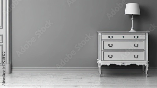 Obraz White commode with lamp against gray wall, wood floor, door frame. Great for ads, interior design mockups, or home decor visuals.