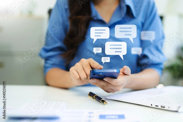 Fototapeta Woman hands  User typing on smartphone and tablet chatting conversation in chat box icon pop up for social media marketing technology concept.