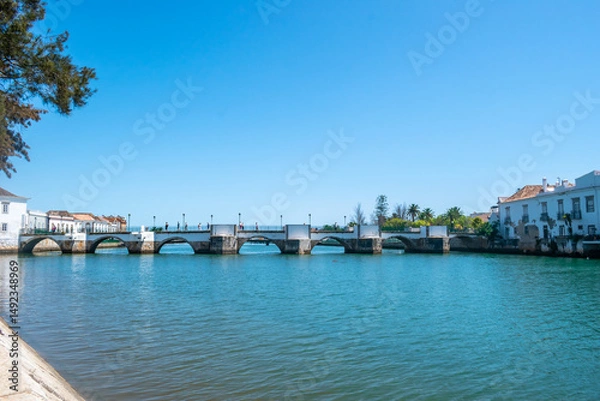 Fototapeta Ancient (Roman) bridge of Tavira over the Gilão river, PORTUGAL
