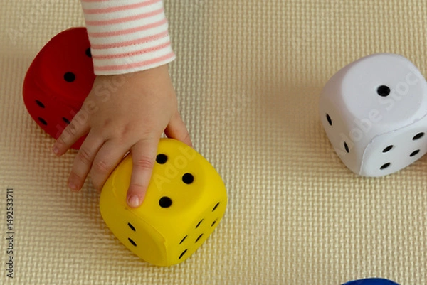 Fototapeta the child takes the dice
