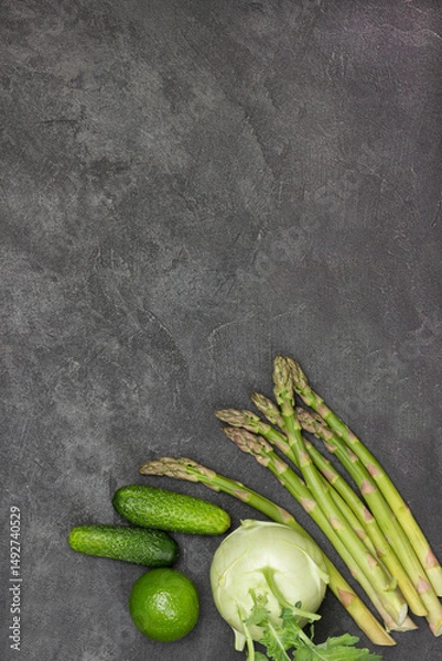Fototapeta Asparagus, cucumbers, lime and kohlrabi on table