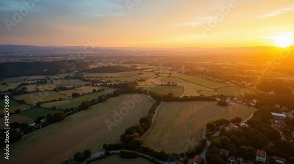 Fototapeta Aerial shot of Tablas de Daimiel in Spain at dawn, showcasing the sunlit landscape below.