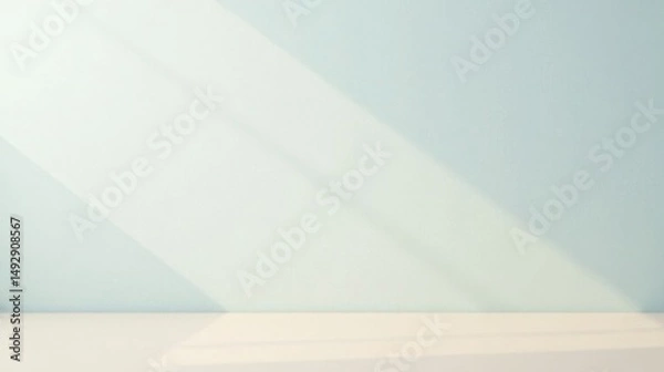 Fototapeta Serene Minimalist Interior Scene with Soft Light and Shadow Play on a Pale Blue Wall and White Surface