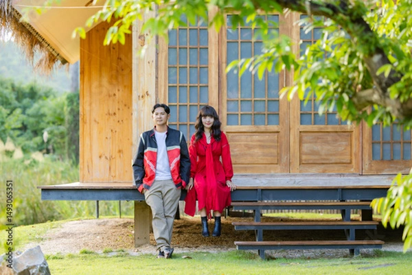 Obraz Romantic time together. Happy asian couple tourist sitting on terrace at a Japanese style homestay at countryside on vacation.