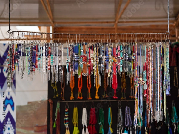 Fototapeta Souvenir shop. A random accessories local souvenir shop in Bukhara bazaar street market including color necklaces and bracelets made from precious stones and beads.