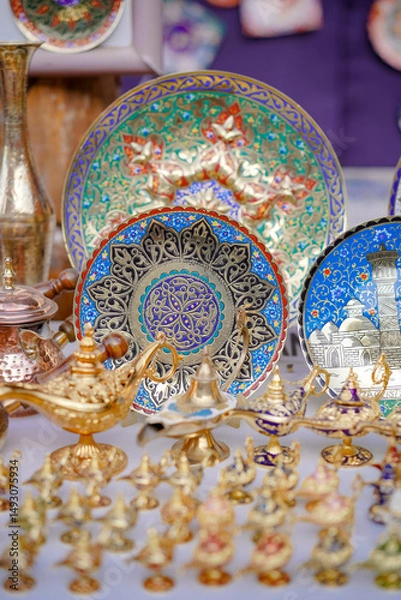 Fototapeta Souvenir shop. A random local souvenir shop in Bukhara bazaar street market including colorful dishes and lamps on display.