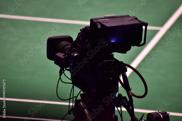 Fototapeta Digital camera for video production at sporting event. TV camera for recording the competition at sport event. TV Professional studio digital video camera.