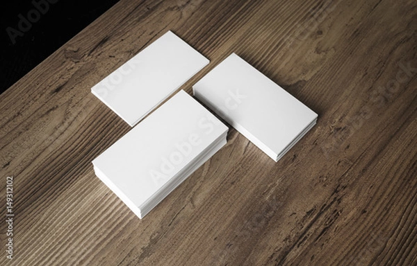 Fototapeta Piles of blank business cards on wood background. Template for your design. Stacks of blank name cards.