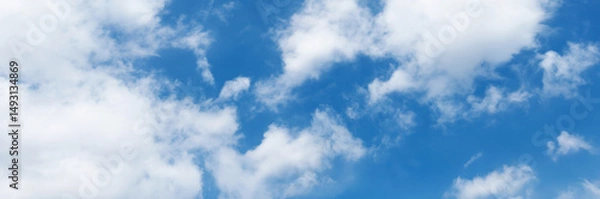 Fototapeta Clear blue sky with a few clouds. The sky is very bright and the clouds are scattered throughout
