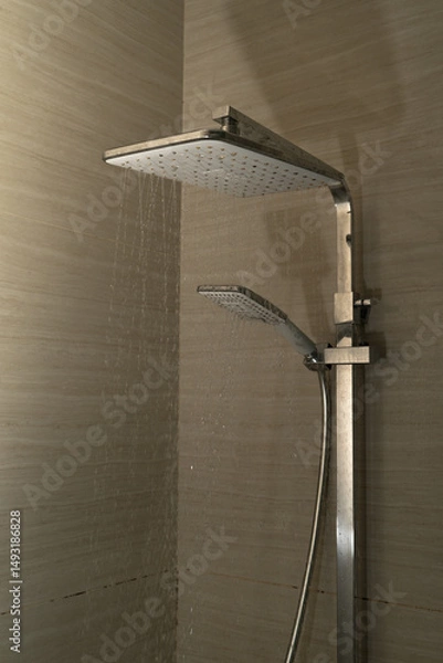 Obraz Shower head spraying water inside a modern bathroom