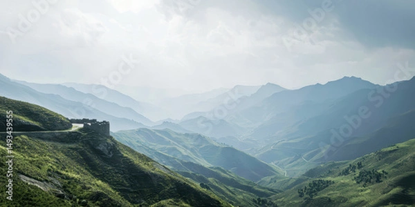 Fototapeta a scenic view of green hills and a winding road 