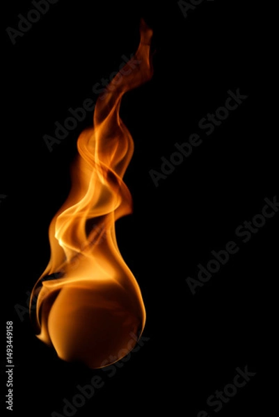 Fototapeta Vibrant Flame Dancing in Darkness with Elegant Flowing Curves