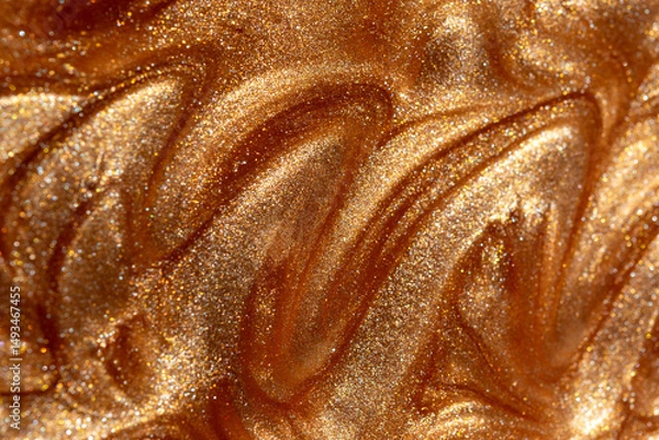 Fototapeta Glowing golden shimmering cosmetic texture of gel or body spray. Background texture for backdrops or mapping.
