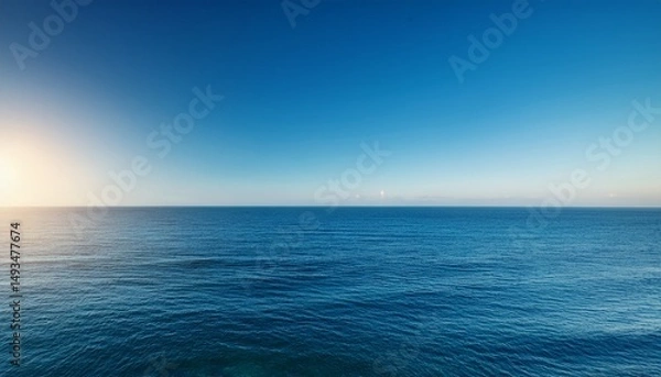 Obraz serene ocean view under a clear blue sky capturing tranquility and vastness at sunrise