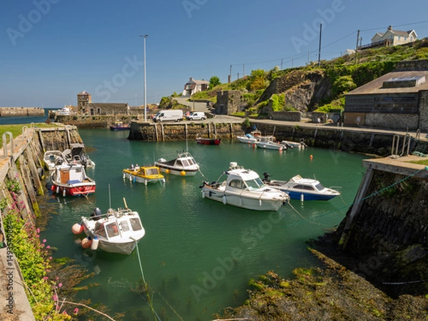Fototapeta Amlwch Anglesey. A small fishing port harbour with many boats docked in it