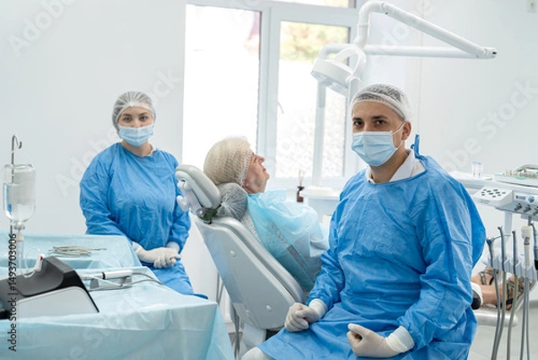 Fototapeta dentist-orthopedic doctor and his assistant examine a young retired woman at clinic