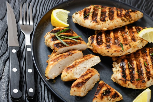 Obraz grilled chicken breast with lemon on a plate