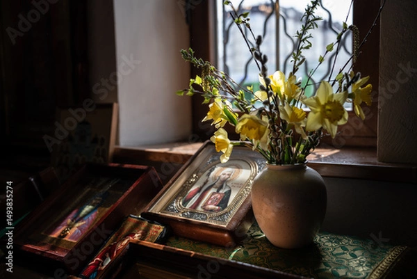 Obraz Yellow bouquet of daffodils and willow trees, icons in the temple