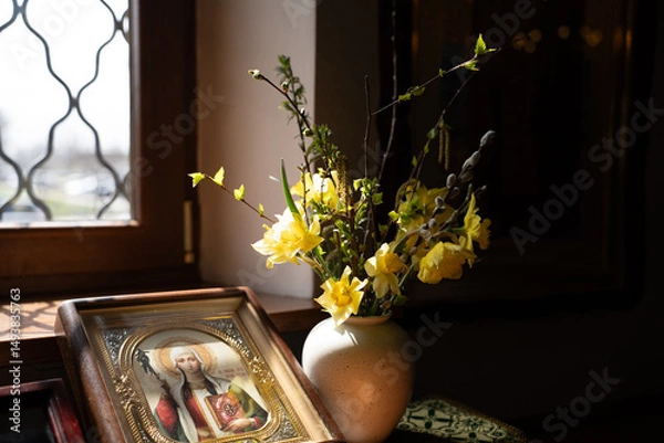 Obraz Yellow bouquet of daffodils and willow trees, icons in the temple