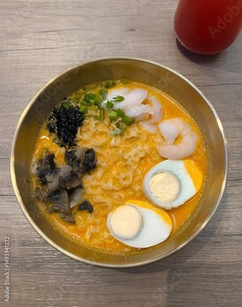 Fototapeta Appetizing ramen bowl with seafood and eggs