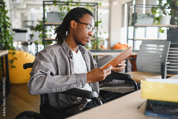 Fototapeta African american student engaged in learning at modern workspace