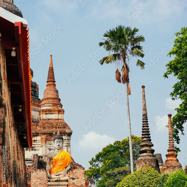 Fototapeta Thailand temple. 1 of most popular tourist attractions in Ayutthaya Historical Park, Thailand is Wat Yai Chai Mongkhon. Selective focus on Big Buddha statue in front of temple Wat Yai Chai Mongkol.