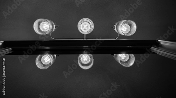 Obraz Looking up at bathroom lights reflecting in mirror in black and white