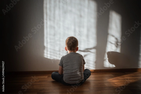 Obraz Little boy lonely depressed standing with back sitting on floor sad autism. autism spectrum disorder, psychological problems, mental health. associative behavior, child does not look into eyes
