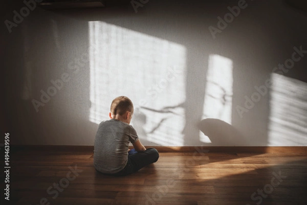 Obraz Little boy lonely depressed standing with back sitting on floor sad autism. autism spectrum disorder, psychological problems, mental health. associative behavior, child does not look into eyes