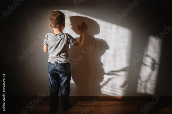 Obraz Little boy lonely depressed standing with back sitting on floor sad autism. autism spectrum disorder, psychological problems, mental health. associative behavior, child does not look into eyes