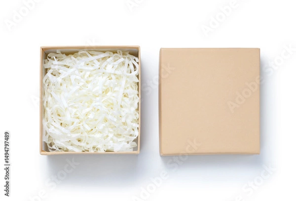 Fototapeta Brown gift box with shredded paper on white background. Top view