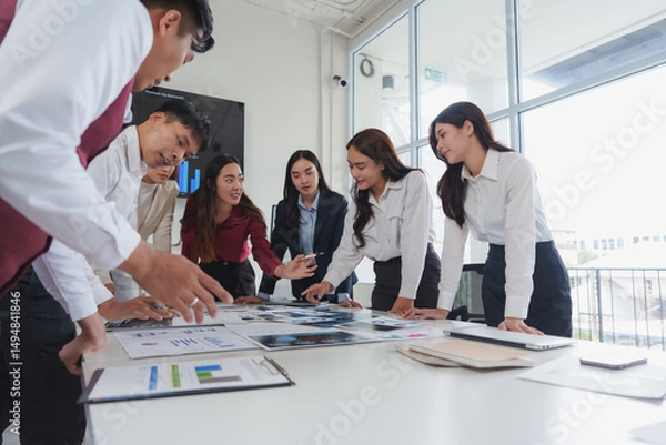 Fototapeta Business team analyzing data and discussing strategy in modern office