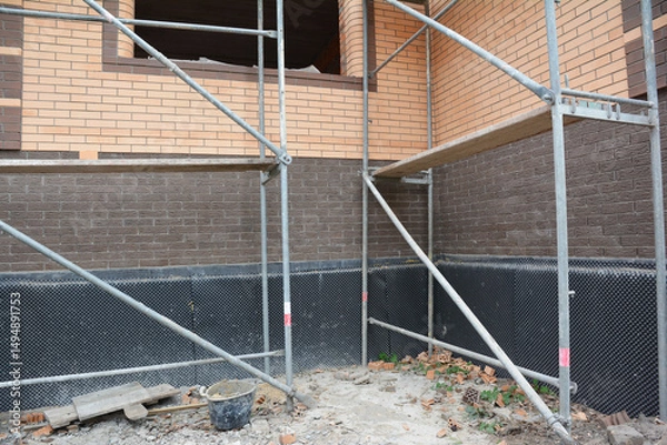 Fototapeta Brick house foundation wall waterproofing in problem corner area.