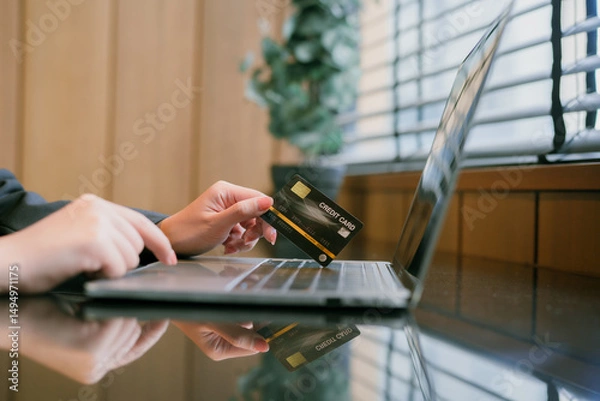 Obraz Asian woman paying with credit card online