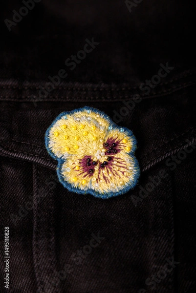 Obraz Pansy, heartsease embroidery brooch with beads on black jeans fabric background, closeup shot, copy space